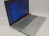 an open laptop computer sitting on top of a white table