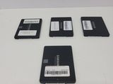 four hard drives sitting on top of each other on a table