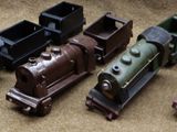 four toy trains that are sitting next to each other on a table