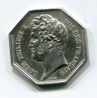 a silver coin with a picture of a woman on it