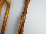 two wooden walking canes that are next to each other