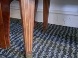 a wooden table with a drawer underneath it on a carpet