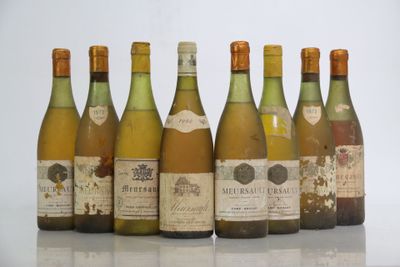 six bottles of wine are lined up in a row on a table