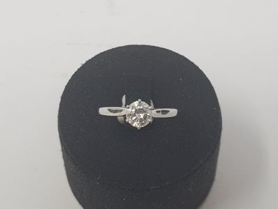 a close up of a diamond ring on a black ring box