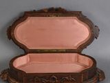 a wooden box with a pink lining inside of it
