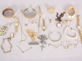 many different types of jewelry displayed on a white surface