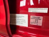 a close up of a red vehicle with a sticker on it