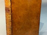 an old book sitting on top of a table next to a white background