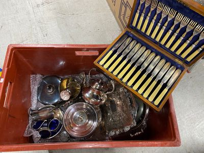 a red box with silverware in it on the floor