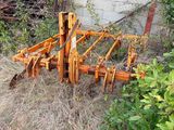 a picture of a tractor plow in a yard