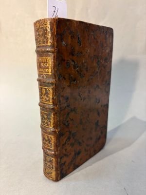 un vieux livre écrit posé sur une surface blanche