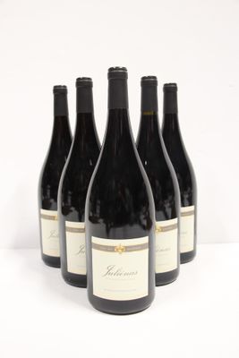 six bottles of red wine are lined up on a white surface