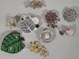 a lot of brooches and brooches on a table