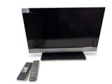 a flat screen tv sitting on a stand next to a remote control