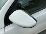 a white car with a mirror on the side of it
