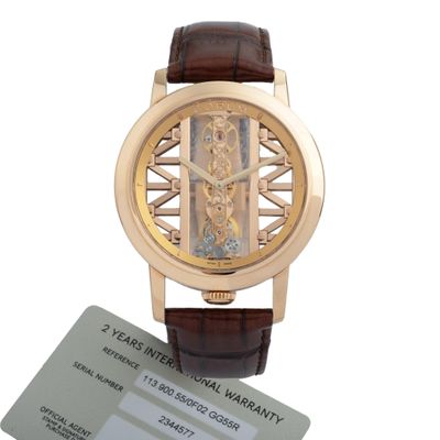 a gold wrist watch with a brown leather strap