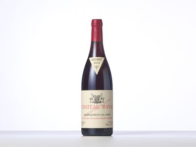 a bottle of red wine sitting on top of a table