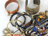 a lot of bracelets and bangles on the table