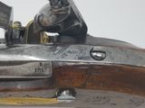 a close up of a gun on a white surface
