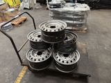 wheels on a cart in a warehouse with pallets of pallets in the background