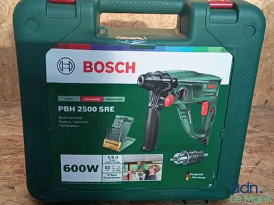 a close up of a green case with a drill and other tools in it