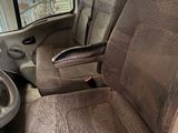 two seats in the back of a truck with a steering wheel