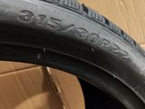 a close up of a tire on a cardboard box with a cardboard box in the background