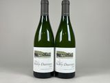 two bottles of wine sitting next to each other on a table