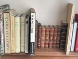 many books that are on a shelf in a room