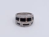 a picture of a ring with black and white stones
