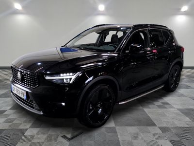the black suv is parked on a checkered floor in a garage