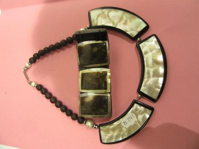 a picture of a necklace that is hanging on a wall