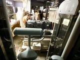 a gym room with a tread machine and other equipment