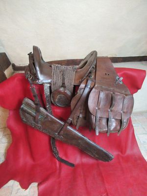a red cloth with a pair of leather gloves and a gun on it