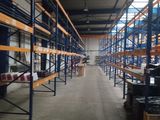 a large warehouse with lots of shelves and pallets