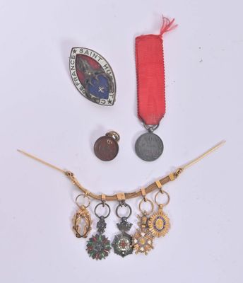 a necklace with a medal, a medal, and a medal on it