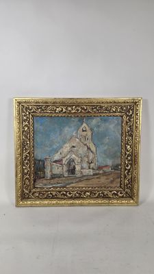 painting of a church in a gold frame on a white wall