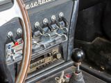 dashboard of an old car with a steering wheel and a control panel