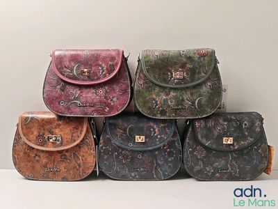 several purses are lined up in a row on a white surface