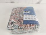 a blanket that is wrapped in plastic on a white surface