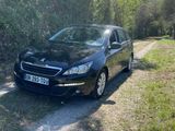 a picture of a black car parked on a dirt road