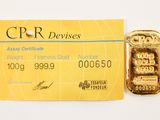 a credit card with a gold bar attached to it
