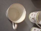 three cups and a saucer on the table