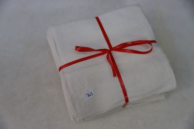 a white napkin with a red ribbon tied to it