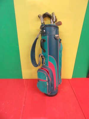 a picture of a blue and red golf bag on a red floor