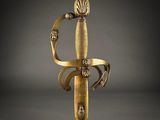 an old sword with a gold handle and a wooden handle