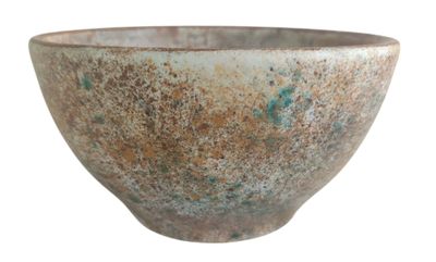 a brown and green bowl sitting on a white surface