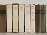 several books are lined up in a row on a shelf