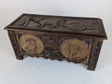 an old wooden chest with carvings on the sides of it
