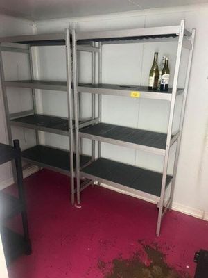 a shelf with bottles of wine on it in the corner of a room